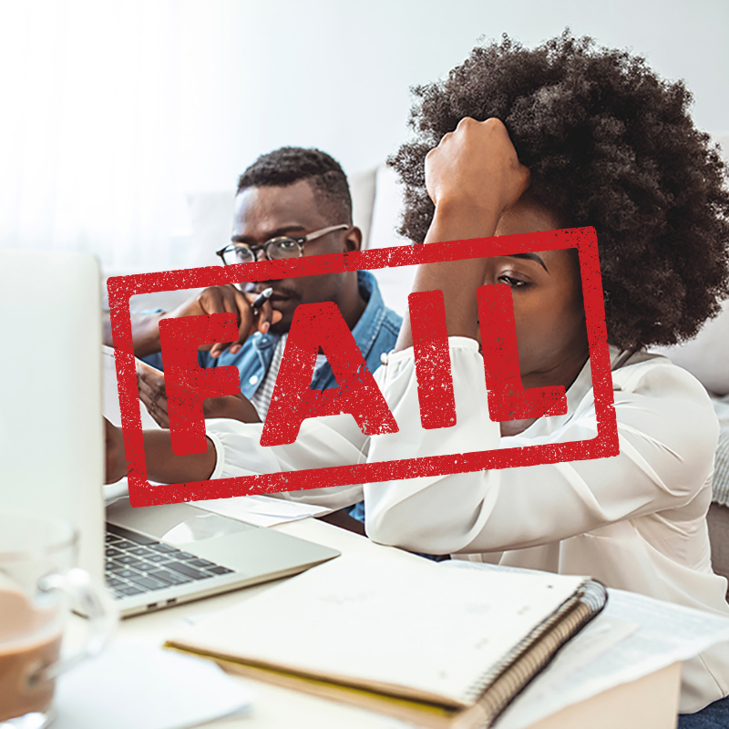 Stressed african american couple looking frustrated, having no money to pay off their debts, managing family budget together, sitting home at kitchen table with lots of papers, laptop and calculator