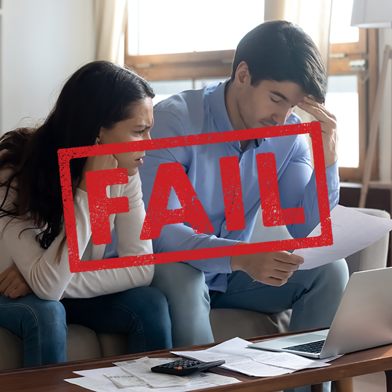 Stressed african american couple looking frustrated, having no money to pay off their debts, managing family budget together, sitting home at kitchen table with lots of papers, laptop and calculator